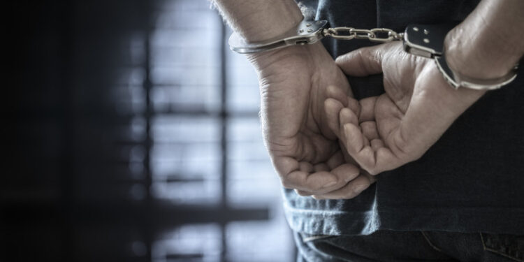 Criminal wearing handcuffs in prison